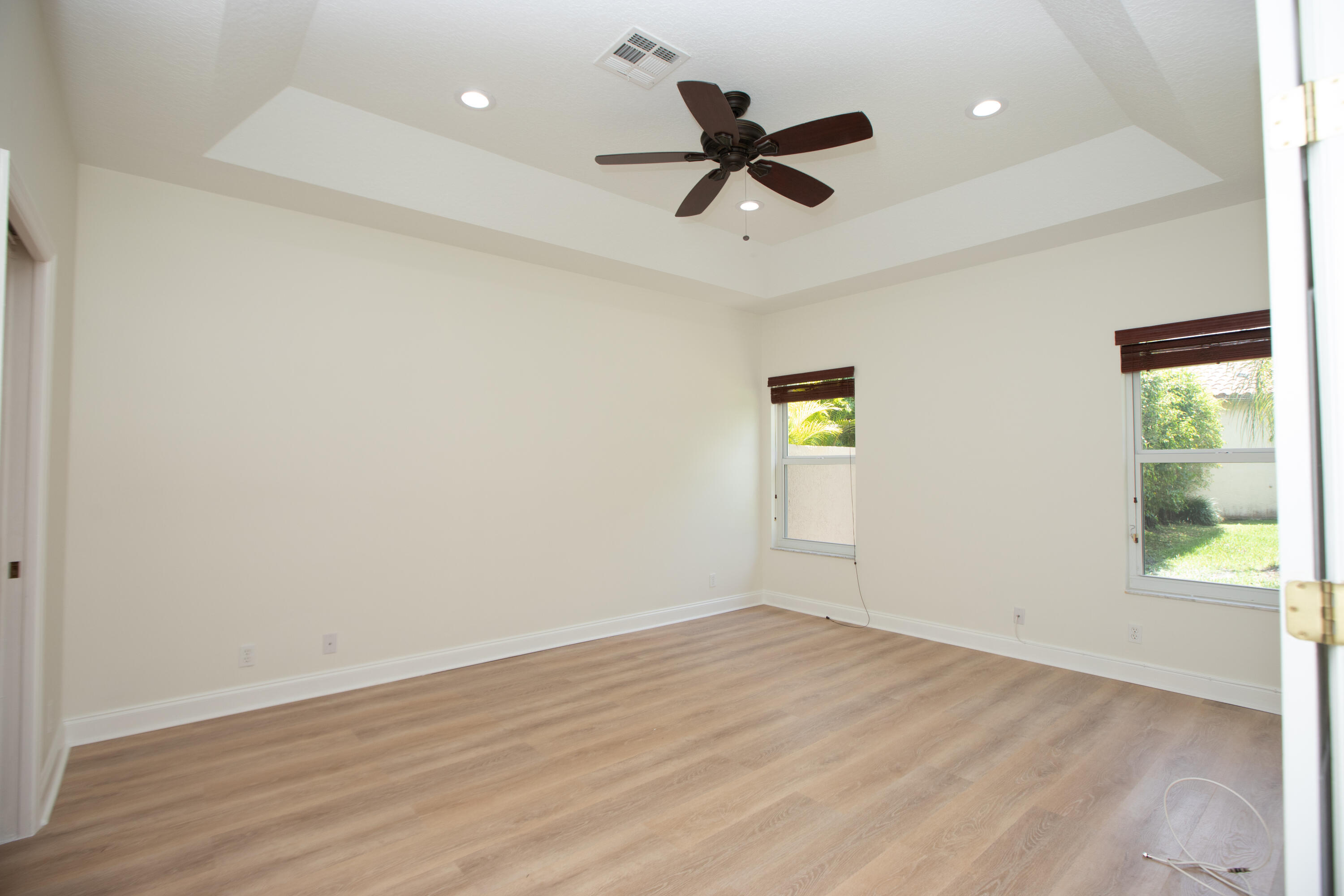 10821 La Salinas Circle Boca Raton, FL 33428 - Photo 16 of 64 a view of empty room with wooden floor and fan