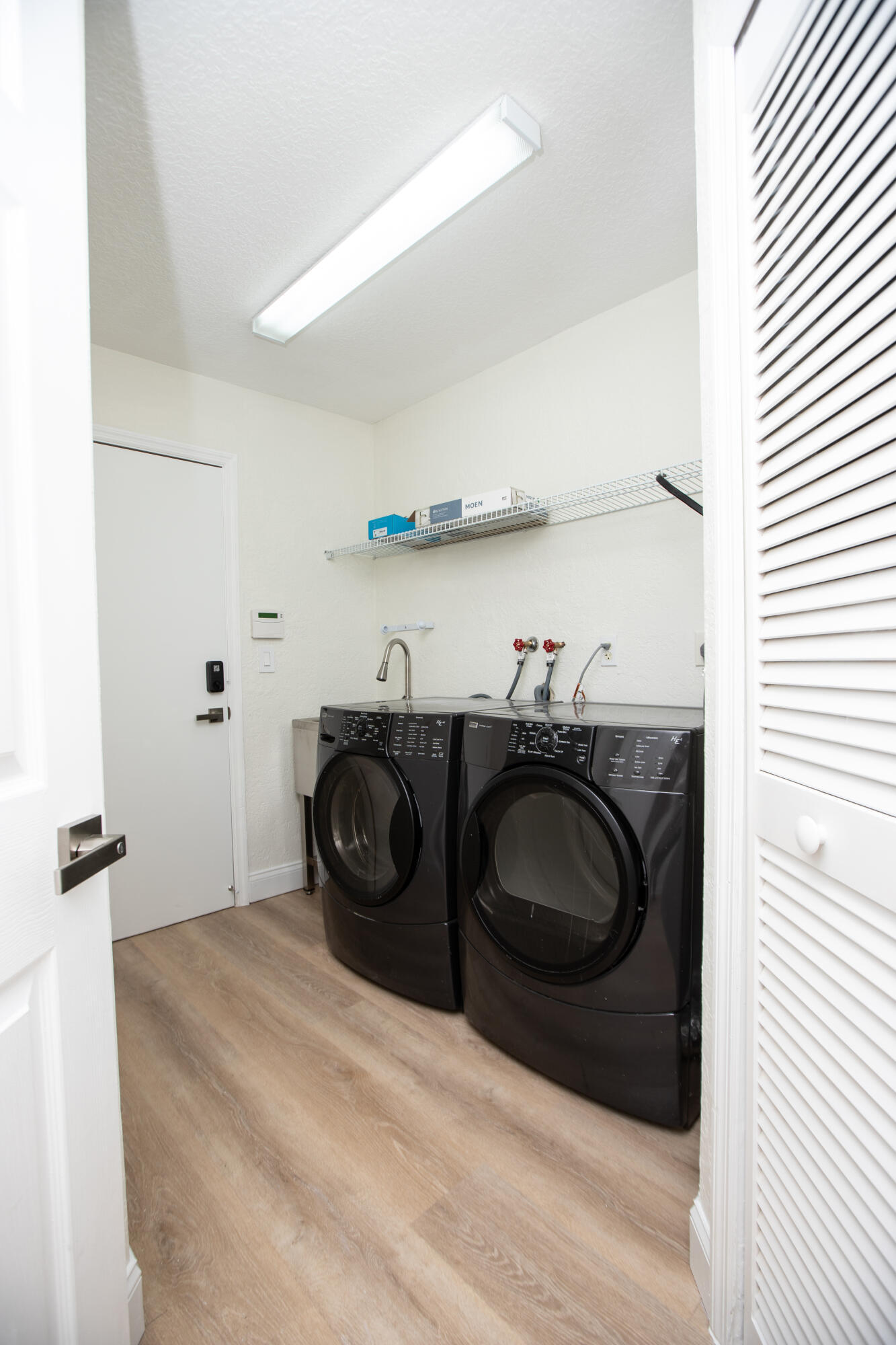 10821 La Salinas Circle Boca Raton, FL 33428 - Photo 31 of 64 a bathroom with a granite countertop sink and a washing machine