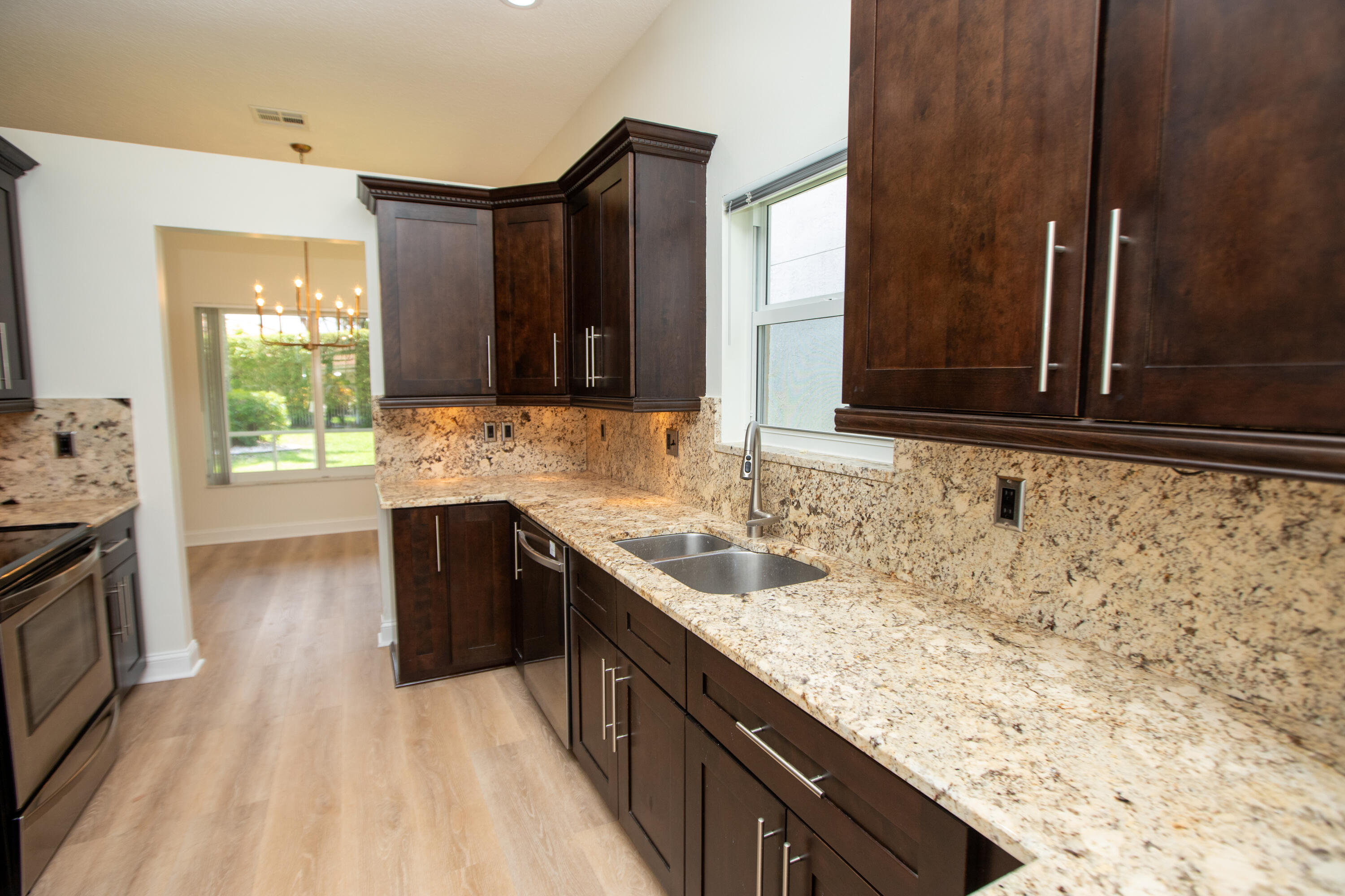 10821 La Salinas Circle Boca Raton, FL 33428 - Photo 4 of 64 a kitchen with granite countertop a sink stove and cabinets