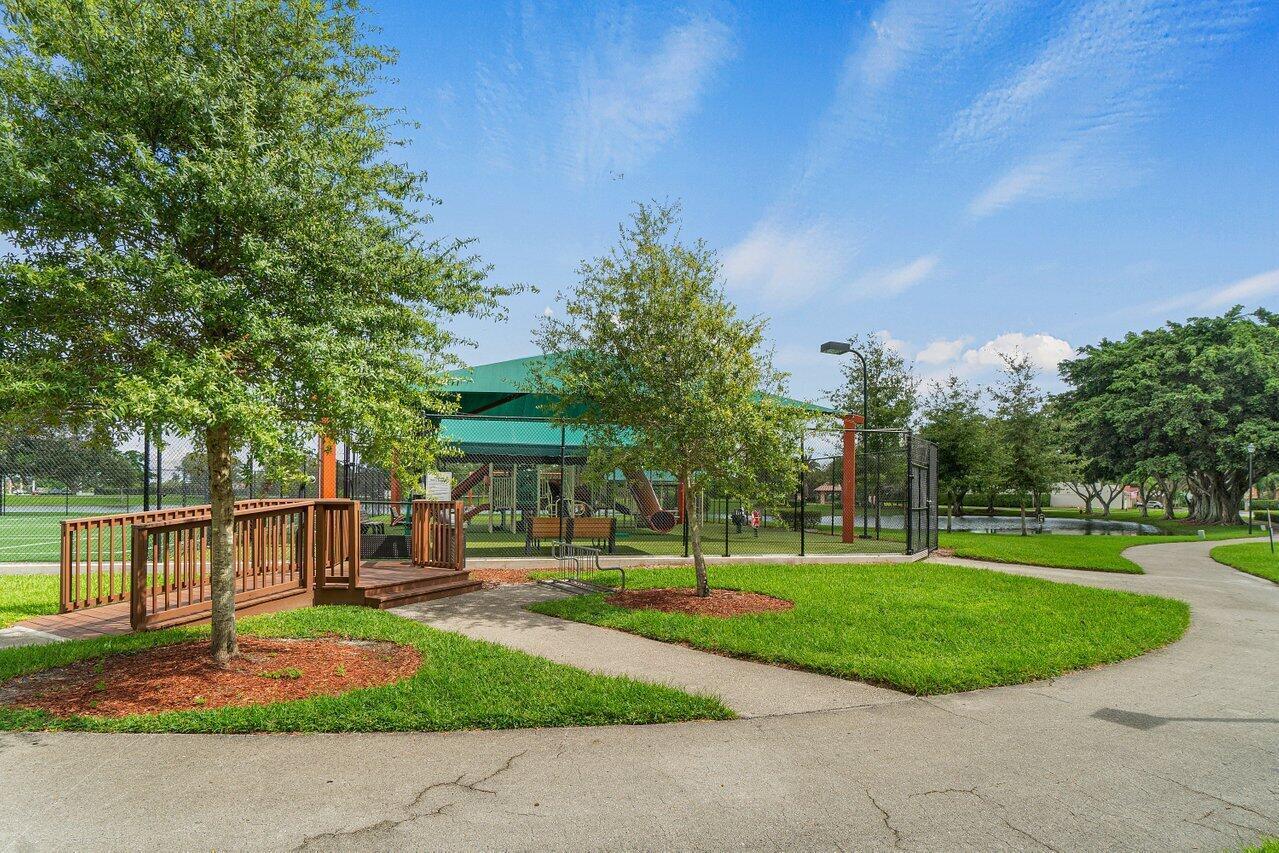 10821 La Salinas Circle Boca Raton, FL 33428 - Photo 44 of 64 a front view of a house with a yard