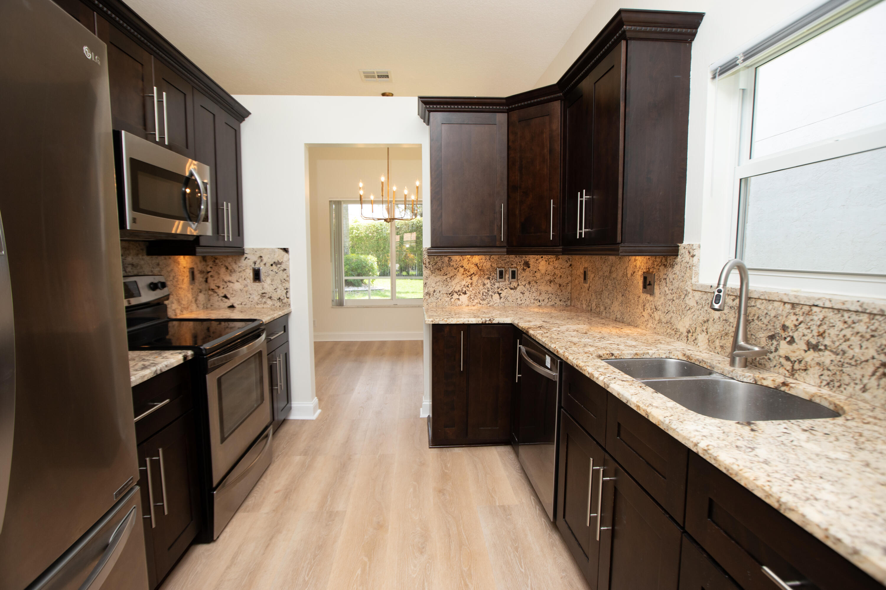 10821 La Salinas Circle Boca Raton, FL 33428 - Photo 5 of 64 a kitchen with a sink stove top oven and refrigerator