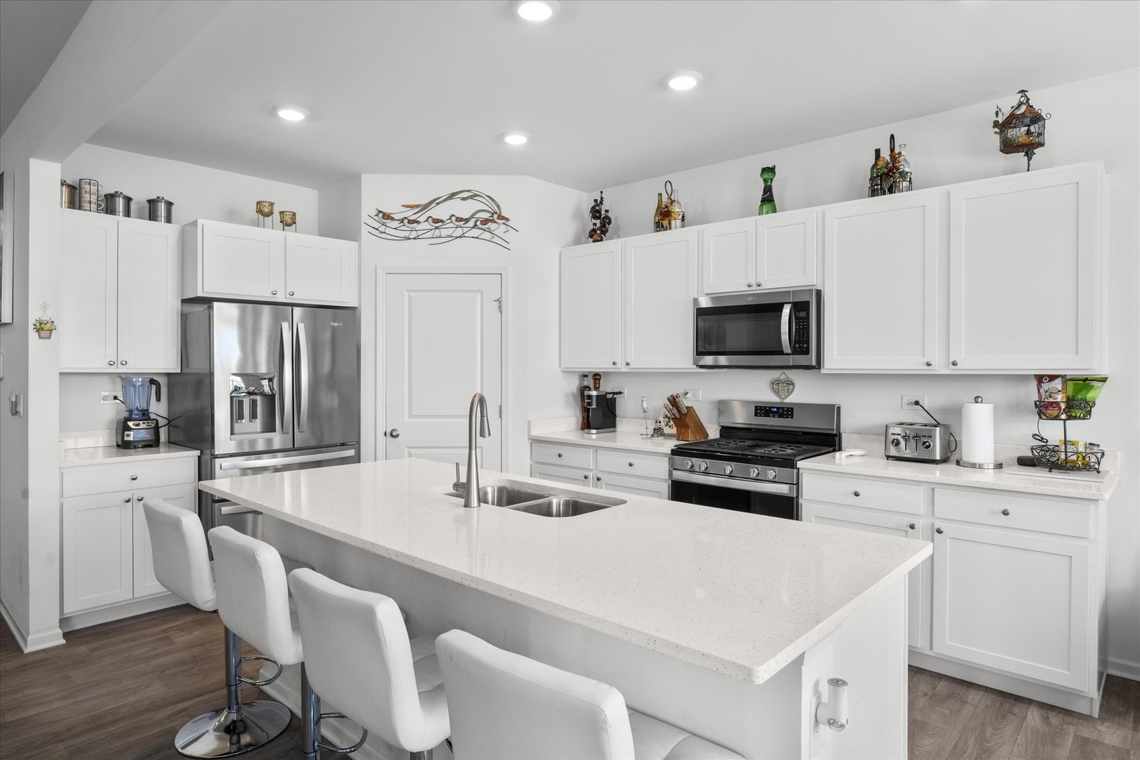 10122 Jonamac Avenue Huntley, IL 60142 - Photo 16 of 27 a kitchen with stainless steel appliances a stove a sink a microwave a refrigerator and cabinets