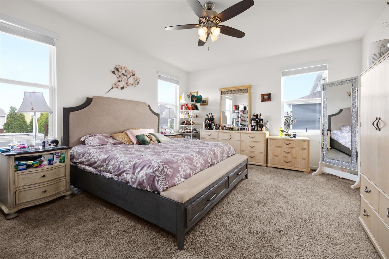 10122 Jonamac Avenue Huntley, IL 60142 - Photo 19 of 27 a spacious bedroom with a bed and a chandelier