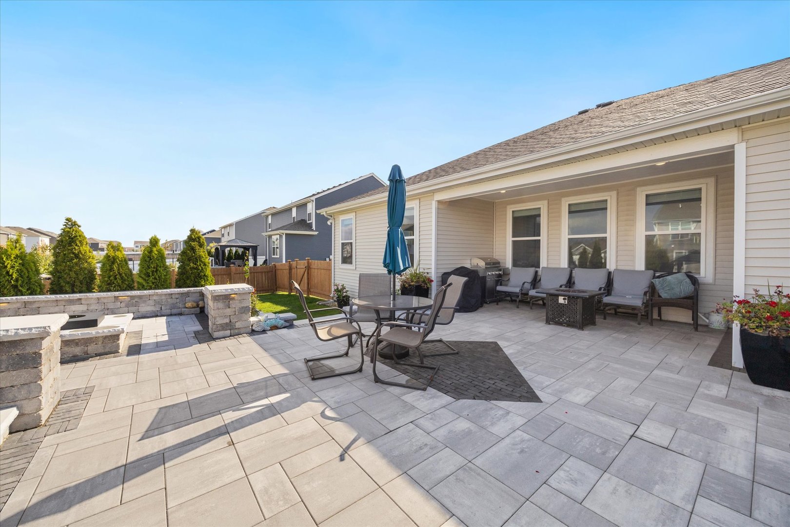 10122 Jonamac Avenue Huntley, IL 60142 - Photo 25 of 27 a view of a patio with dining table and chairs with wooden fence
