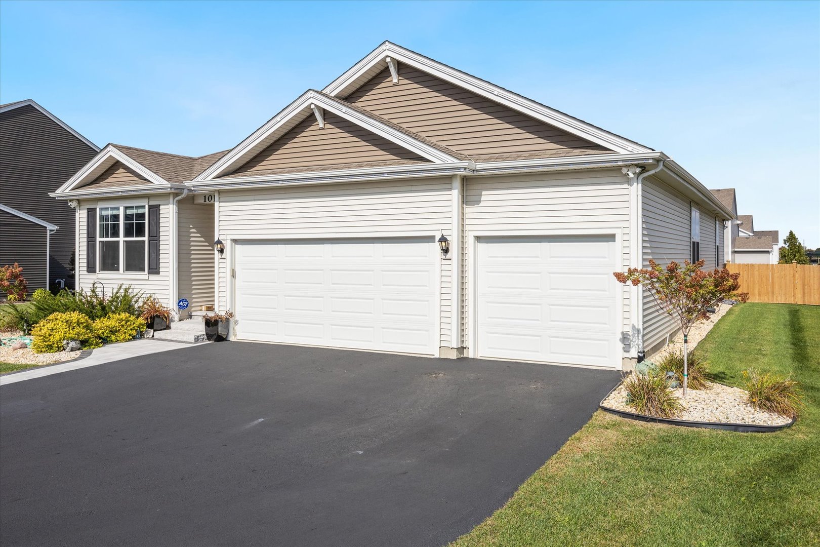 10122 Jonamac Avenue Huntley, IL 60142 - Photo 4 of 27 a front view of a house with a yard and garage
