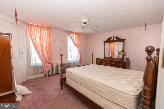 a bedroom with a bed and a view of bathroom