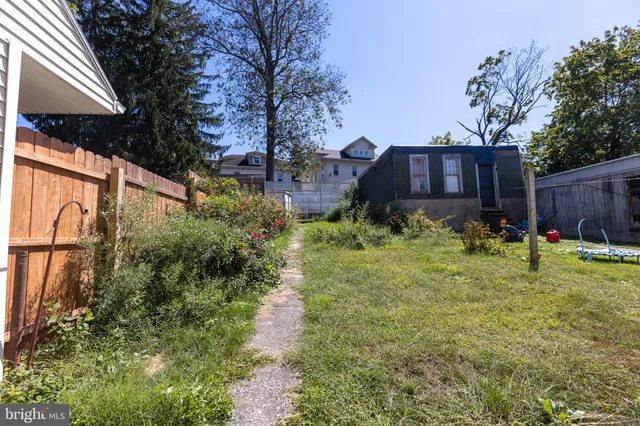 a view of a large building with a big yard and large trees