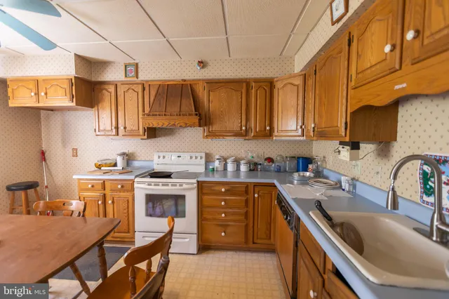 a kitchen with a stove a sink and a refrigerator