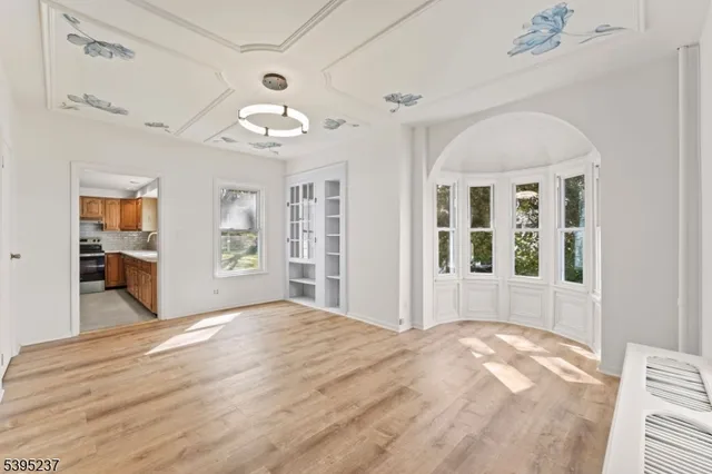 a large bedroom with wooden floor closet and a bathroom