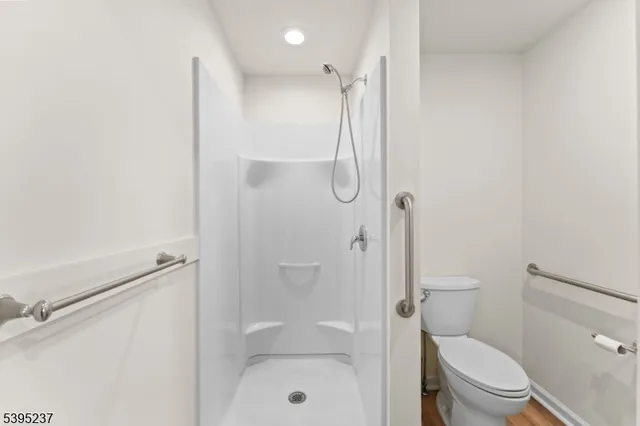 a bathroom with a shower a toilet and sink