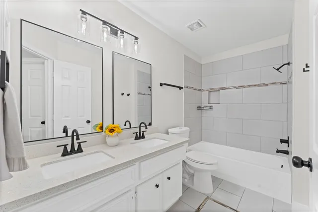 an empty room with ceiling fan and window