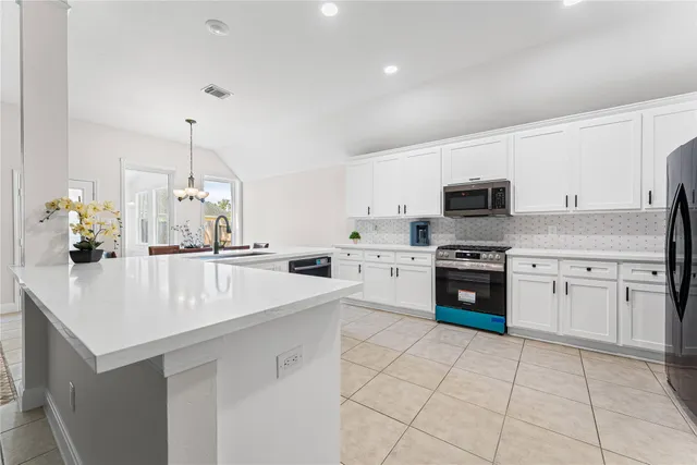 a kitchen with a sink a stove and cabinets