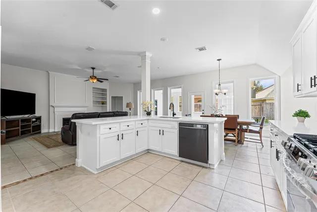 a kitchen with cabinets and chairs