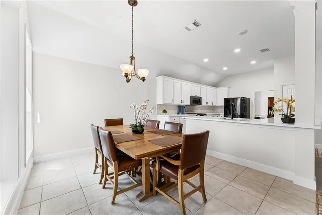 a view of a dining room and a kitchen with a dining table chairs