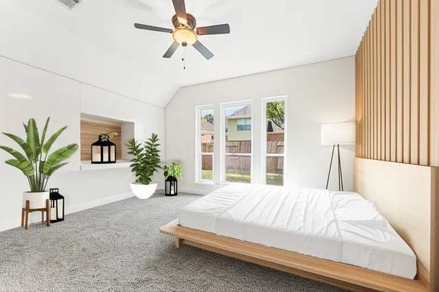 a bedroom with a large bed and a chandelier