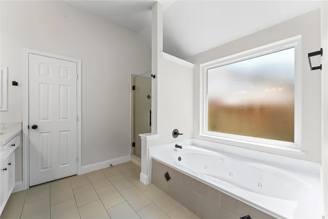 a bathroom with a bathtub and a shower