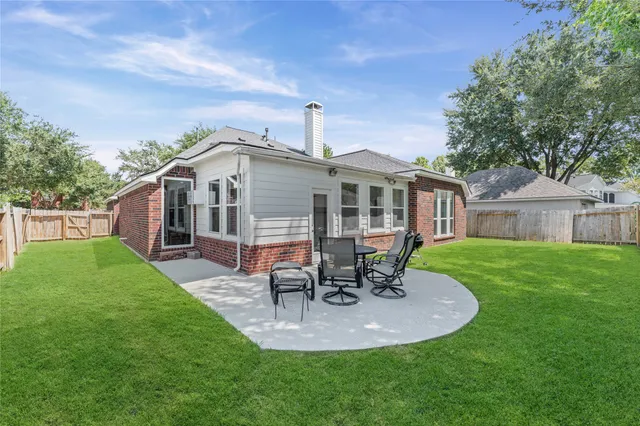 a view of a house with backyard porch and sitting area