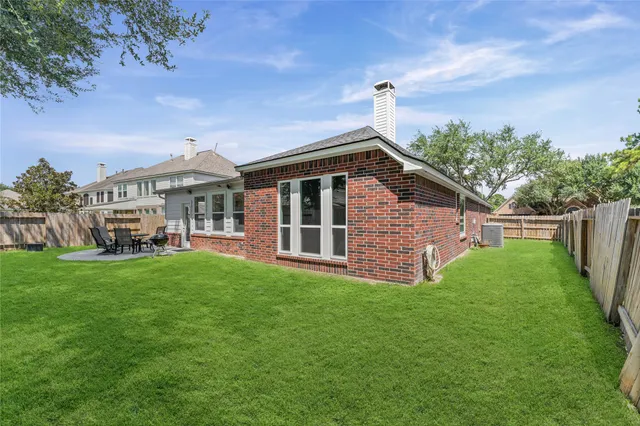 a view of a house with backyard and porch