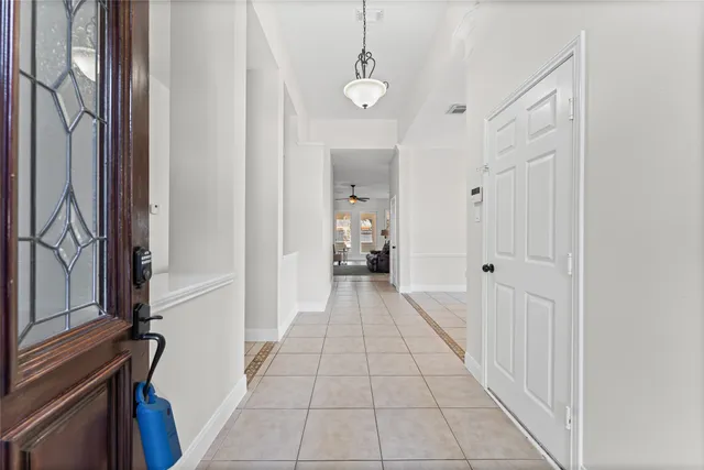 a view of a house with brick walls and a yard with plants