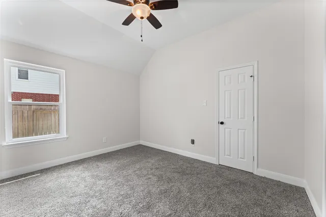 a bedroom with a bed and a flat tv screen on dresser