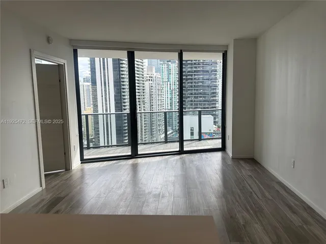 a living room with wooden floor and furniture