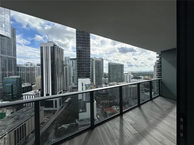 a kitchen with wooden floors and wooden cabinets