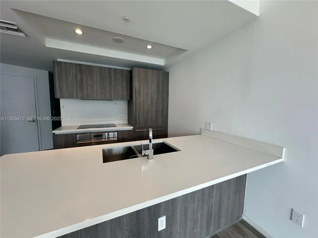 a room with a wooden floor and a sink