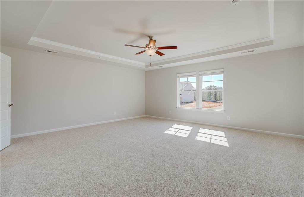228 Ruthe Cove Locust Grove, GA 30248 - Photo 23 of 31 an empty room with windows and fan
