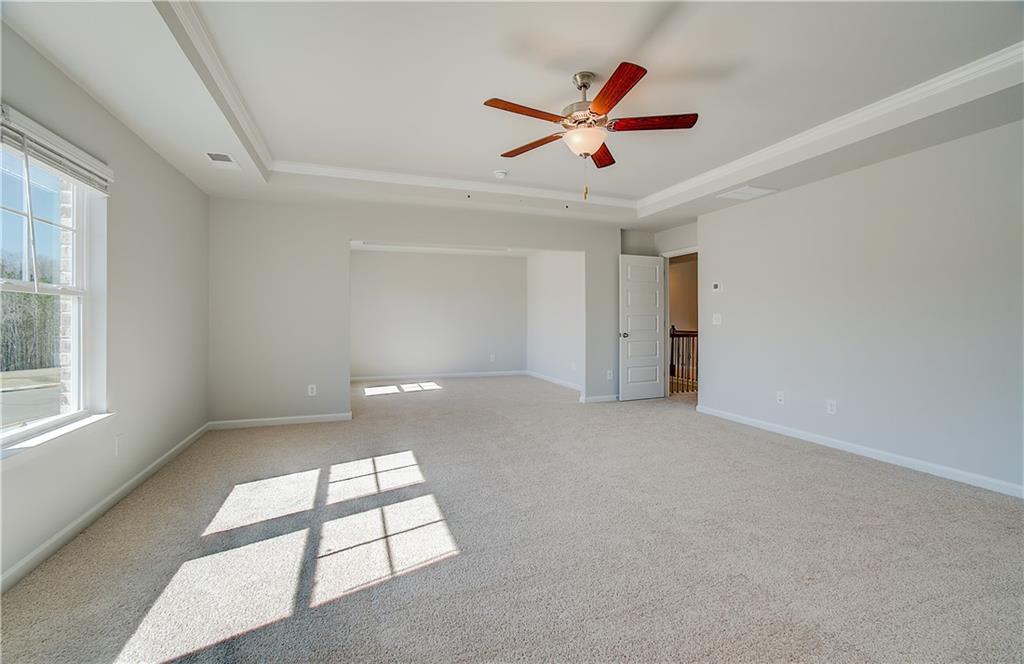 228 Ruthe Cove Locust Grove, GA 30248 - Photo 24 of 31 an empty room with windows and ceiling fan