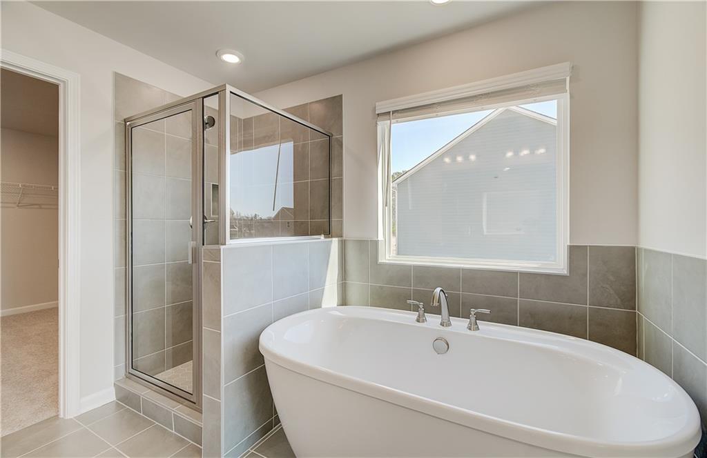 228 Ruthe Cove Locust Grove, GA 30248 - Photo 27 of 31 a white bath tub sitting next to a white sink
