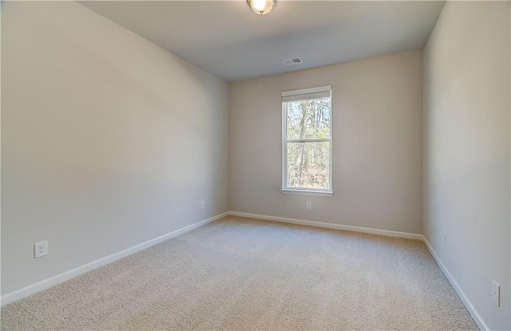 228 Ruthe Cove Locust Grove, GA 30248 - Photo 6 of 31 an empty room with a window