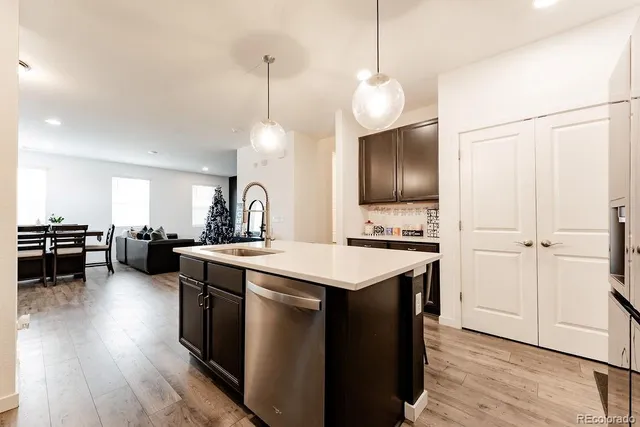 a kitchen with stove a sink and refrigerator