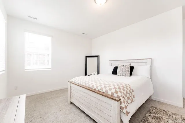 a bedroom with a bed and window