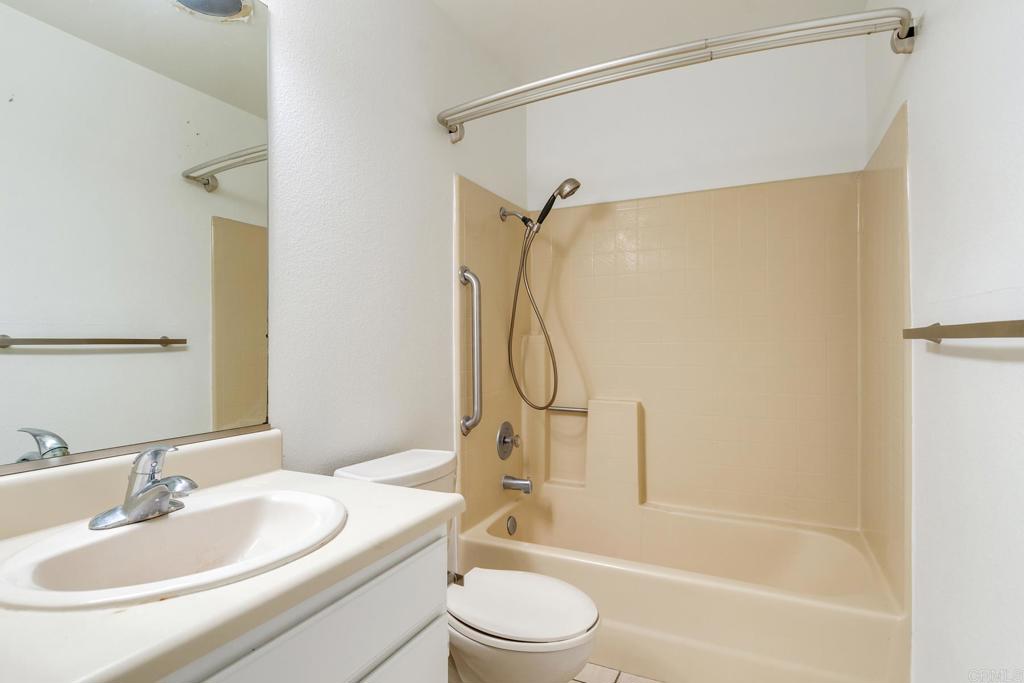 4791 Macadamia Court Oceanside, CA 92057 - Photo 16 of 20 a bathroom with a sink toilet and shower