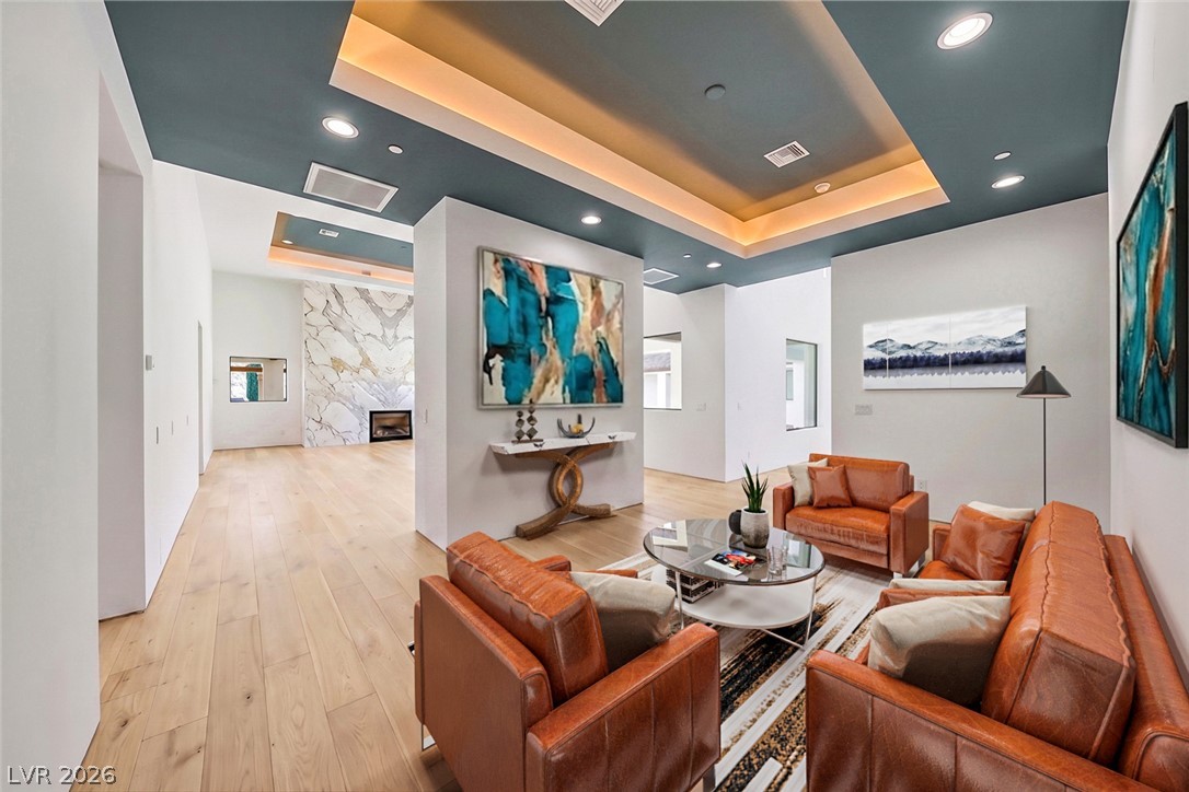 1140 Julie Road Henderson, NV 89002 - Photo 66 of 71 Recessed lighting illuminates the striking tray ceiling and rich hardwood floors of this inviting living space.