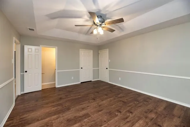 a bathroom with a granite countertop sink toilet and mirror