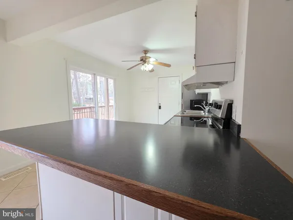 a view of kitchen and dining room with wooden floor