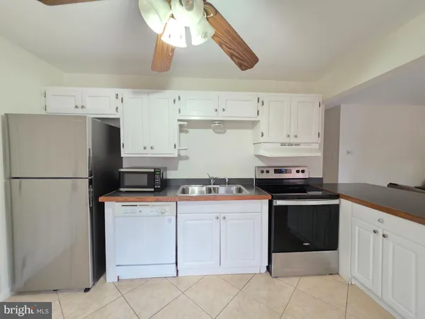 a kitchen with cabinets appliances and a counter space