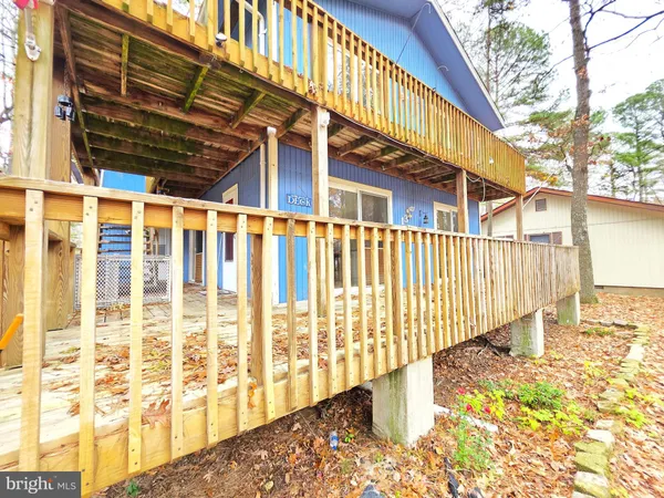 a view of a house with a wooden fence