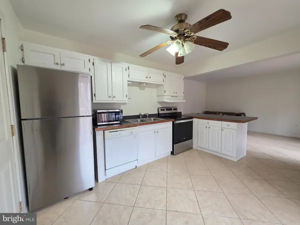 a kitchen with a refrigerator a sink and cabinets