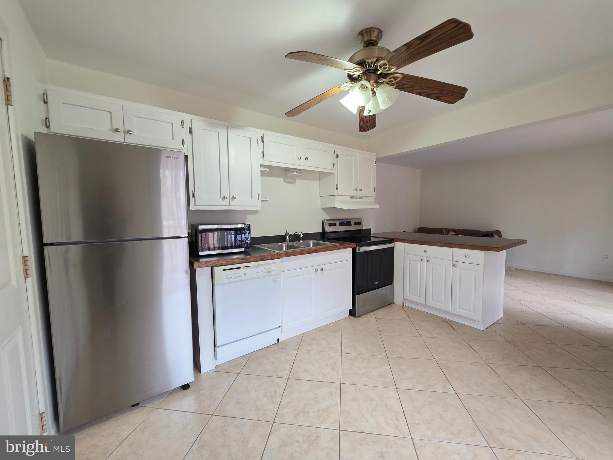 13 Sailors Way Ocean Pines, MD 21811 - Photo 7 of 33 a kitchen with a refrigerator a sink and cabinets