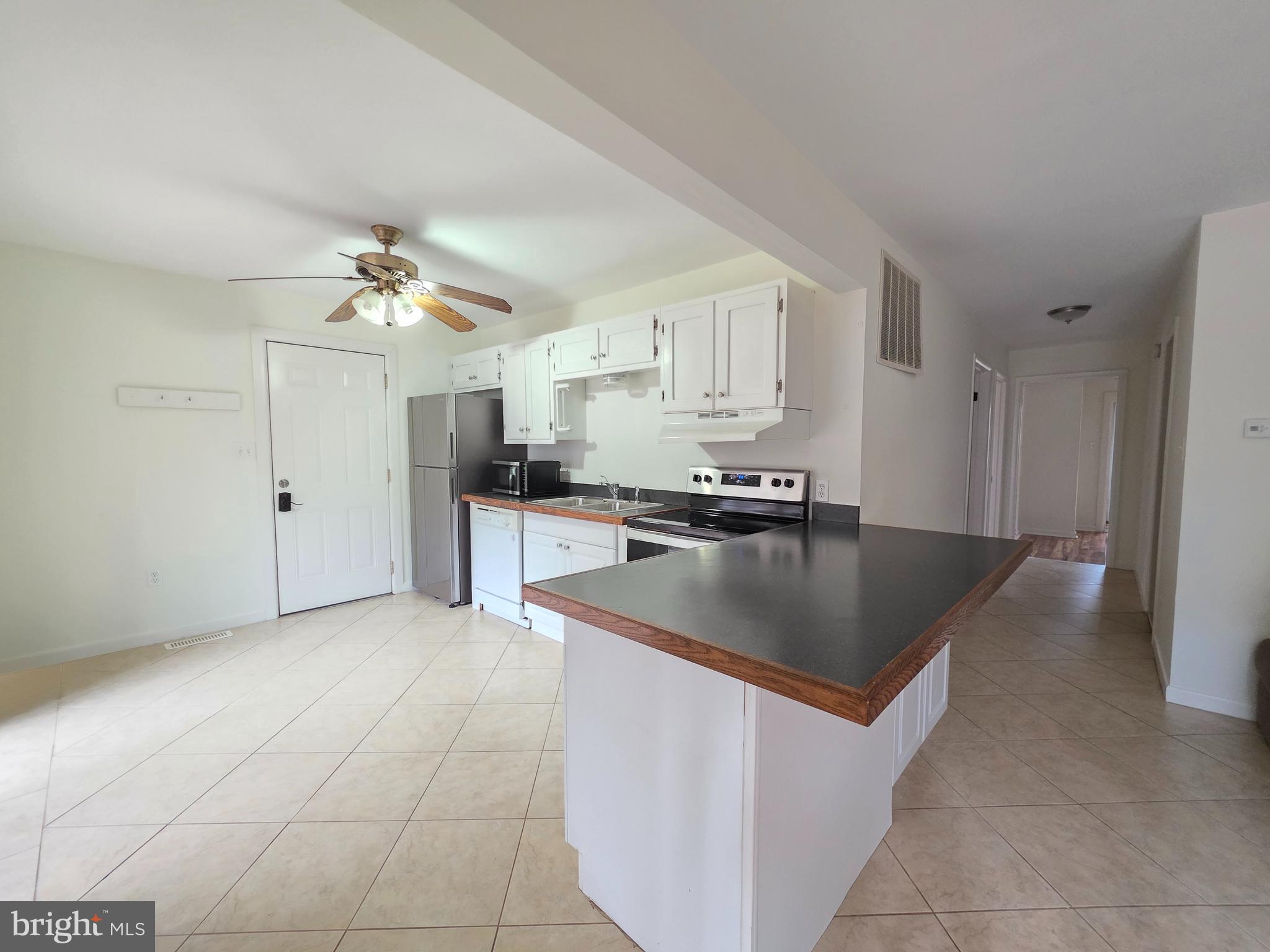 13 Sailors Way Ocean Pines, MD 21811 - Photo 9 of 33 a kitchen with stainless steel appliances granite countertop a sink a stove and a refrigerator