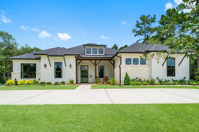 a front view of a house with a garden