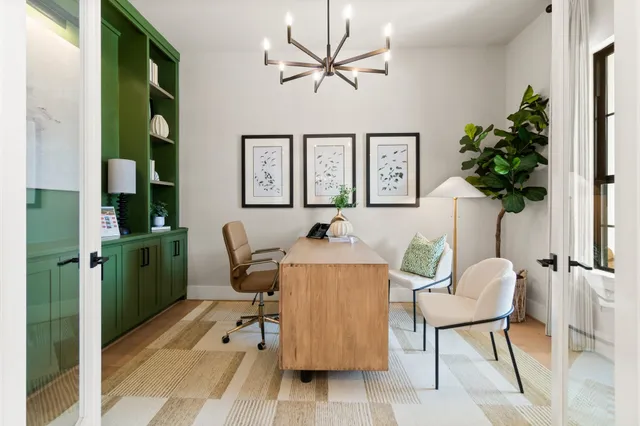 a living room with furniture and a potted plant