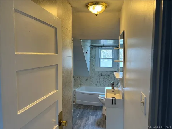 a bathroom with a bathtub and a shower