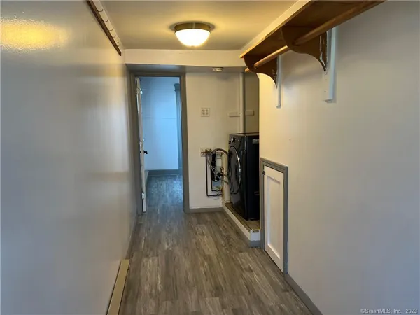 a view of hallway with wooden floor