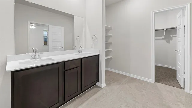 a bathroom with a double vanity sink and mirror