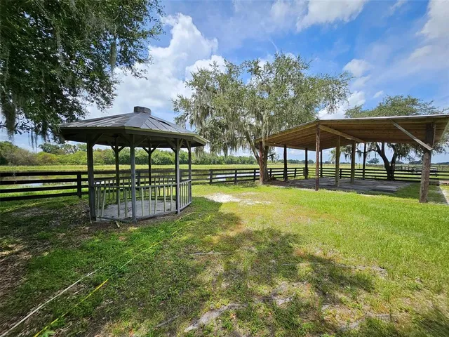 a view of a table and chairs under an umbrella