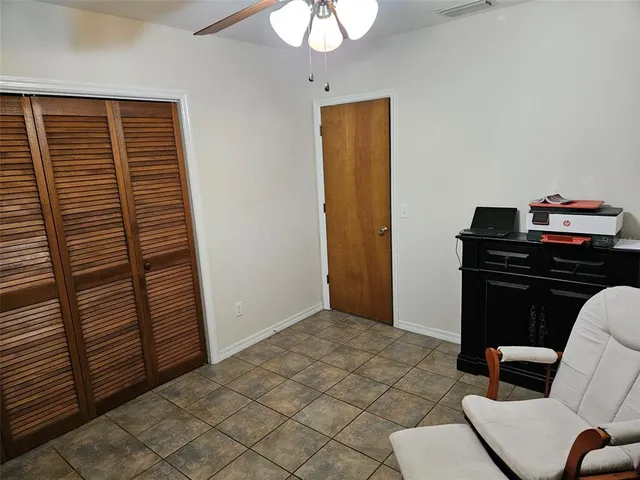 a view of a dining room with furniture and a chandelier fan