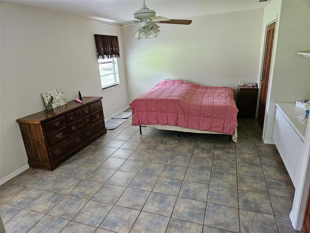 2596 96th Street Arcadia, FL 34266 - Photo 42 of 59 a bedroom with a bed and a dresser